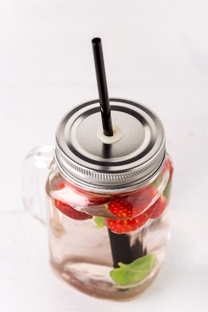 Mug of Delicious Refreshing Drink of Strawberry on White Wooden Background Infused Detox Water