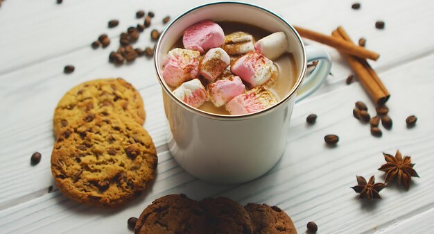 A mug of hot chocolate with marshmallows and chocolate chips