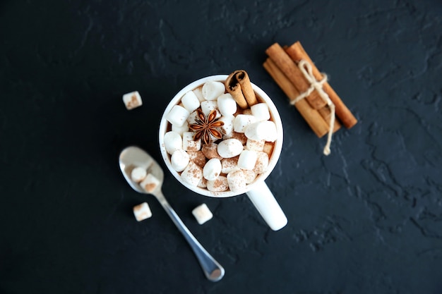 Mug of hot chocolate with marshmallows. Top view, copy space.