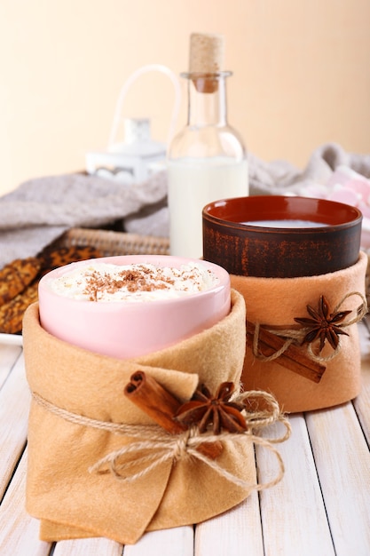 Mug of hot drink decorated in felt on wooden table