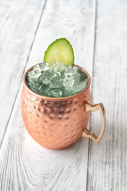 Mug of Sober Mule mocktail garnished with cucumber