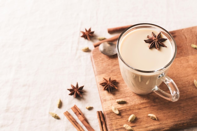 Mug of spice latter tea or coffee winter and autumn hot drink on white background copy space