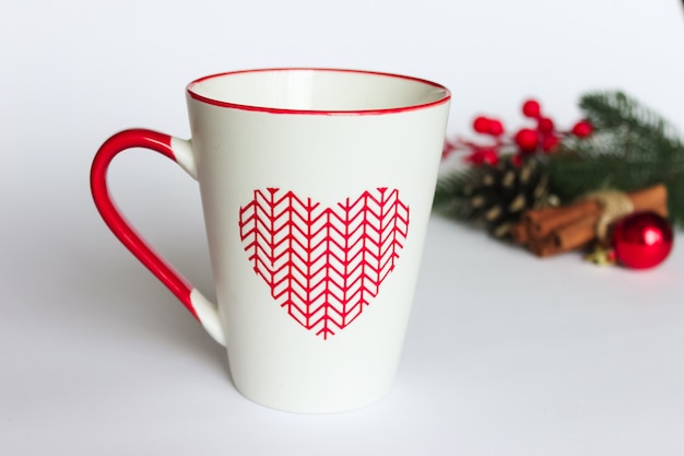 Mug of tea with christmas decorations on white background.