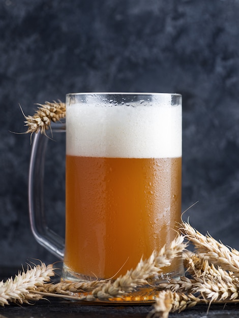 A mug of unfiltered wheat beer on a dark background