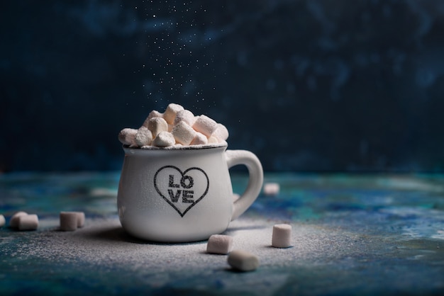 Mug with hot chocolate cocoa drink and marshmallow