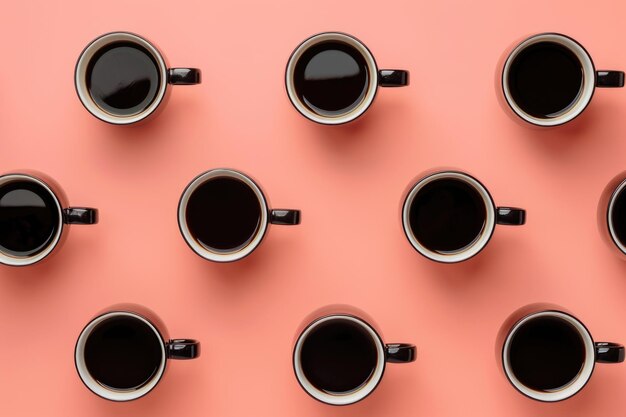 Mugs of black coffee in rows against peach background