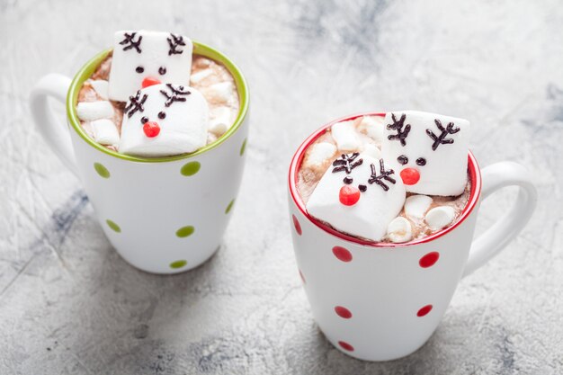 Mugs with hot chocolate and melted marshmallow