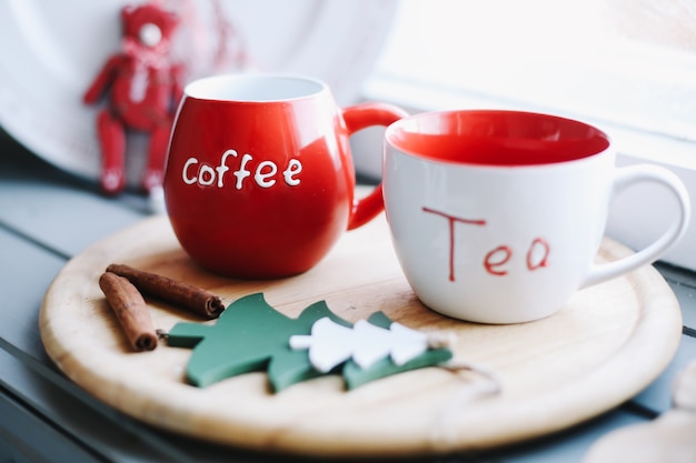 Mugs with tea and coffee on a wooden tray Winter New Year Christmas concept