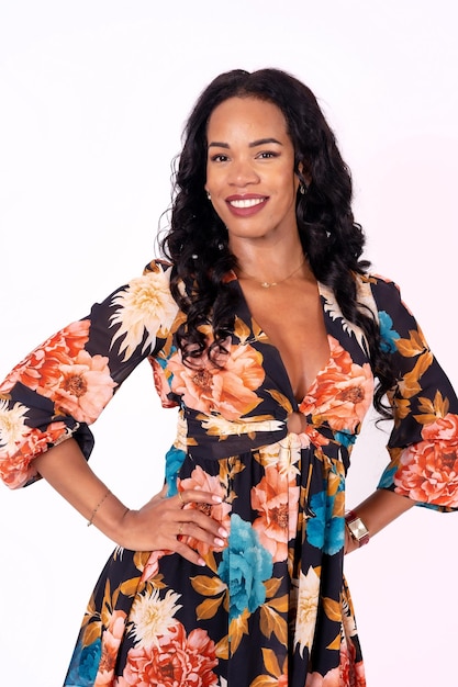 Mulatto woman having fun dancing on a white background cuban traditional dance