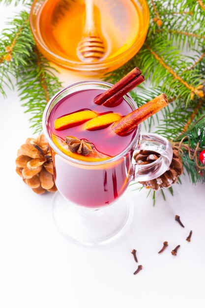 Mulled wine in glass mug with spices Glasses of mulled wine with cinnamon anise and fir tree