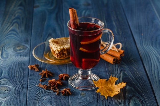 Mulled wine in glass mugs with spices and pear fruits. Autumn still life. Vintage stylized