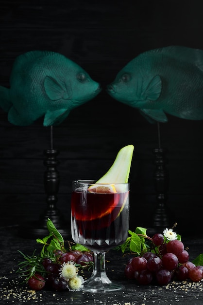 Mulled wine in glasses Citrus fruits and cinnamon sticks Top view On a black background