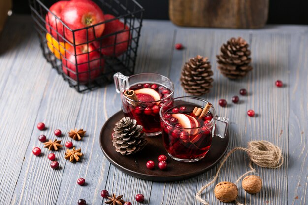 Mulled wine in glasses with and apples, cranberries, cinnamon and star anise