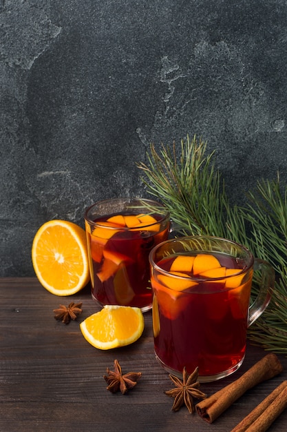 mulled wine glasses with fir tree branches on wooden table