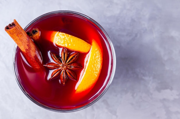 Mulled wine on gray background Christmas mulled wine with orange star anise and cinnamon