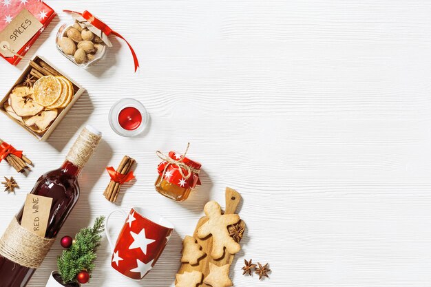 mulled wine ingredients christmas holiday hot winter drink bottle red wine dried fruits candy honey spices red mug on white wood