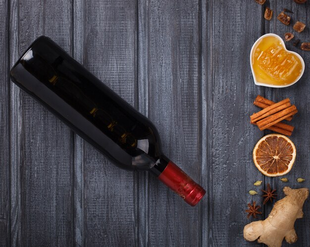 Mulled wine and ingredients: Honey, orange, cinnamon sticks, cloves , ginger, cardamom and sugar.