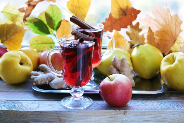 Mulled wine organic fruits autumn leaves spices on a wooden table Thanksgiving