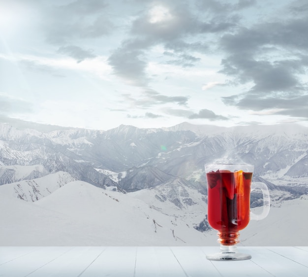 Mulled wine spiced and landscape of mountains on background Alcohol hot drink
