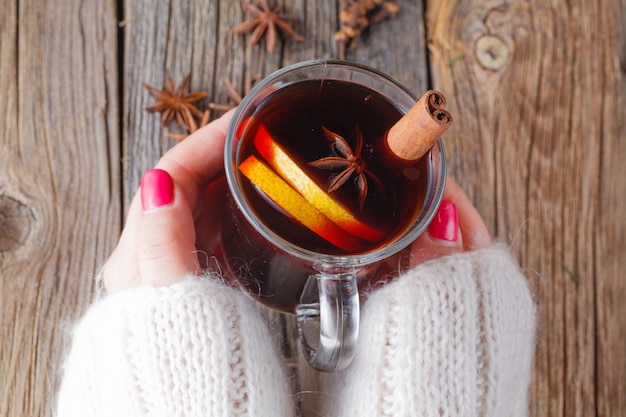 Mulled wine and spices on weathered wooden table