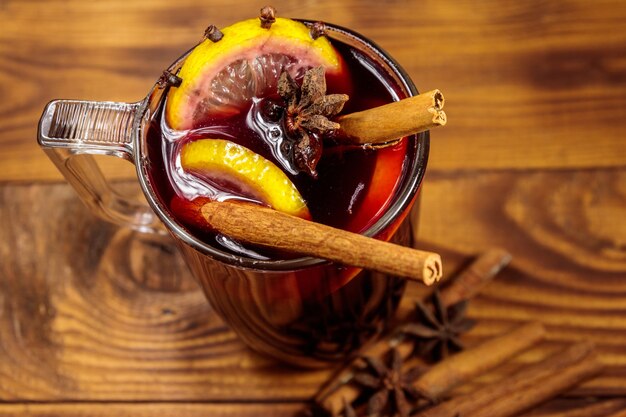 Mulled wine and spices on wooden table. Top view