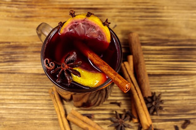 Mulled wine and spices on wooden table. Top view