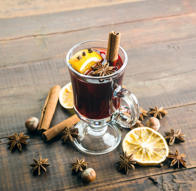 Mulled wine and spices on wooden .