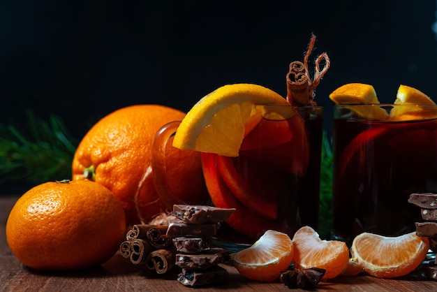 Mulled wine with aromatic spices on a wooden background