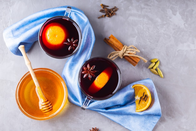 Mulled wine with orange and spices in cups