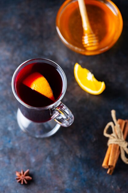 Mulled wine with orange and spices in glass mugs