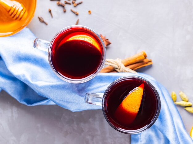 Mulled wine with orange and spices in glass mugs