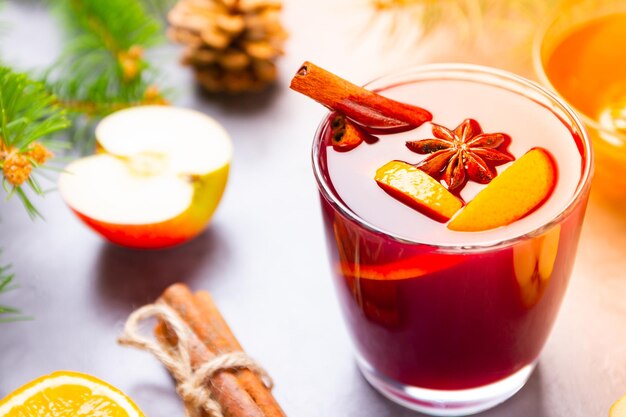 Mulled wine with spices in glass close up Red mulled wine with cinnamon anise and honey