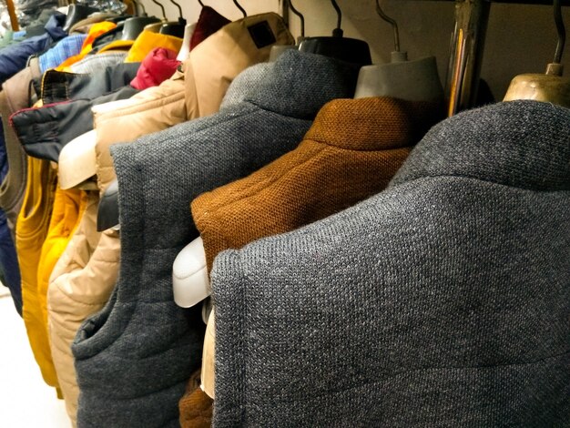 Photo multi color jackets hanging from hangar in a garment shop for sale