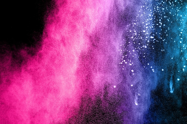Multi color powder explosion on black background.