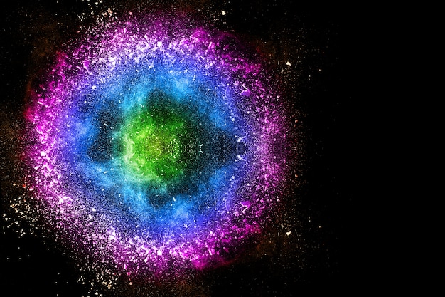 Photo multi color powder explosion on black background.