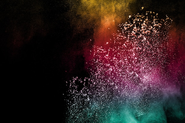 Multi color powder explosion on black background. 