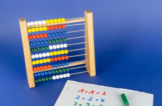 Multi colored abacus against blue background