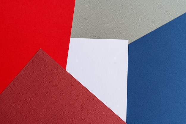 Multi colored abstract paper of pastel Blue,red,gray and white colors palette, with geometric shape, flat lay.