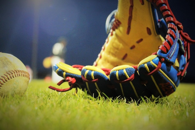 Photo multi colored baseball glove on grassy field