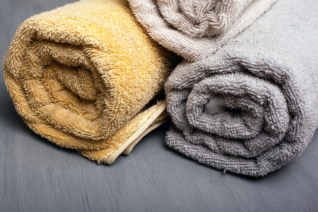 Multi-colored bath towels on a gray