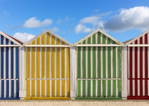 Multi colored beach huts against sky