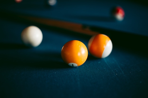 Multi-colored billiard balls on a blue table