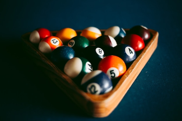 Multi-colored billiard balls on a blue table