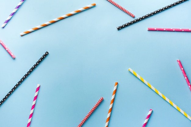 Multi-colored biodegradable paper tubes for drinks and cocktails. The concept of a party, celebration, birthday. Flatlay. Copy space