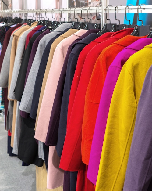 Multi-colored coat hanging on hangers