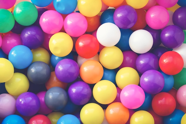 Multi-colored designer background. Many colorful balls for fun and jumping on kids playground. Close-up. Background for children's holiday. Children's birthday.