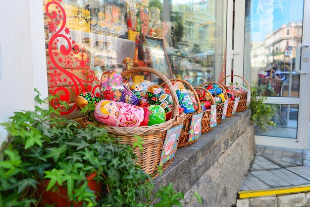 Photo multi colored dolls in basket for sale at market