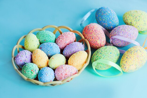 Multi-colored Easter eggs in a basket. Spring decor.