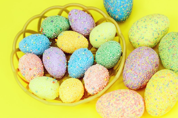 Multi-colored Easter eggs in a basket. Spring decor.
