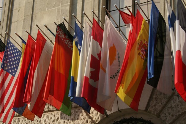 Photo multi colored flags hanging outside building